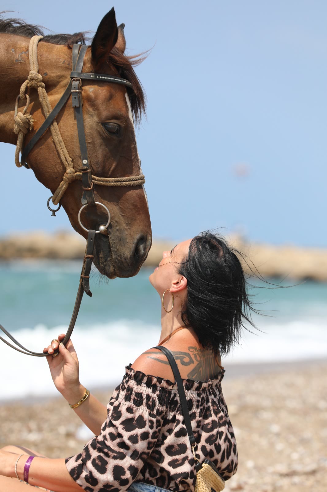 A quiet moment between rider and horse by the sea